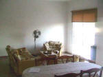 In the living area a three seat sofa-bed, 2 arm chairs, coffee table, TV, a/c unit and built-in wardrobe.