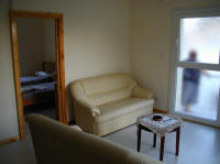 The living room has 2 sofas, TV and DVD player