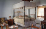 Details such as this four poster bed give Maroni villa a delightful feel about it
